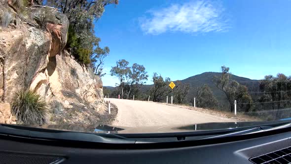 Gopro tracking shot of a car driving through forest and rocks over an ...