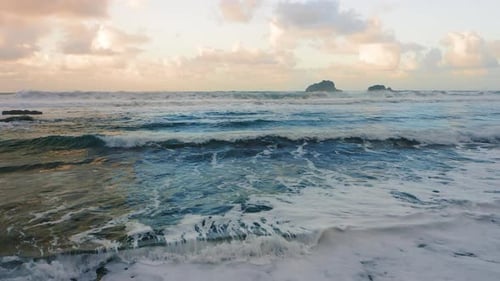 Closeup to Ocean Waves Roll to Rocky Volcanic Shore in Stormy Wather Tenerife Island