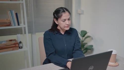 Woman Working on Laptop at Home
