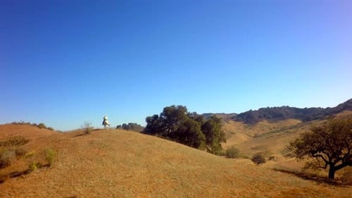 Cowboy On Horseback Traveling On Mountain Range On Sunny Day Slow Motion 8