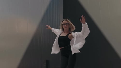 Woman Dancing in Front of an Urban Wall