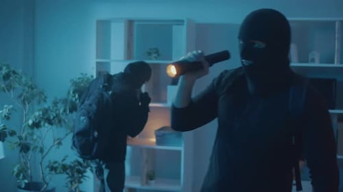 People in Masks with Flashlight Walking in Home