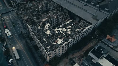 Ash and coal of skyscraper neighborhood after fire. Burned down building in USA.Aerial top down.