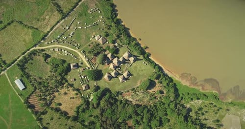 Aerial Top Down Indonesia Farmland with Ornated Roofs Houses at Kodi Village Landscape Sumba Island