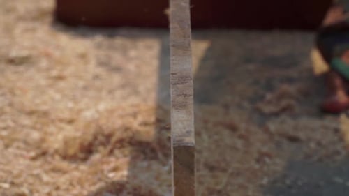 Electric Planer Smooths a Wooden Beam