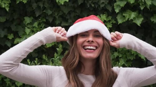 Woman Wearing Santa Hat Smiling Outdoors