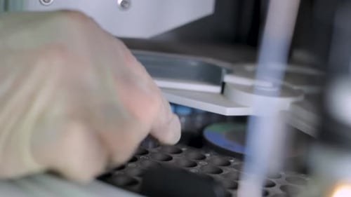 Placing a Solution Sample in Laboratory Centrifuge, Close Up