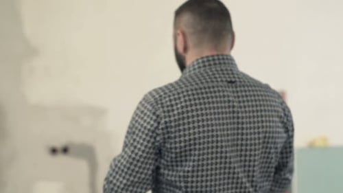 Man takes pictures of new home with cellphone for real estate documentation