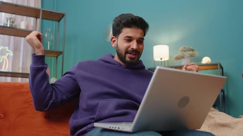 Young Man Video Conferencing on Laptop at Home