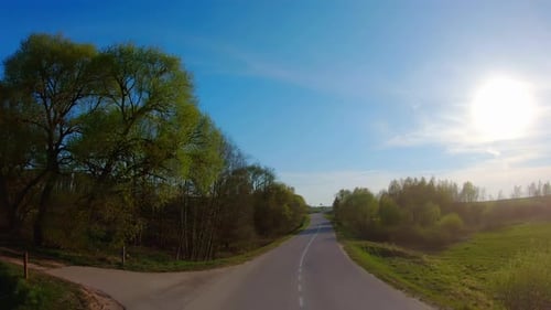 On a rural road in spring, rear view