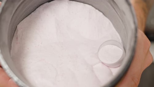 Pile of Creatine Powder for Sports, Supplement for Endurance and Energy Boost in Muscles, Close-Up.