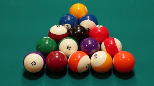 Pool Balls are Broken on an 8 Ball Triangle Rack Closeup on the Spot with Solid and Striped Billiard