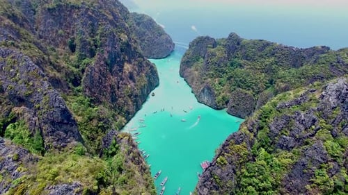 Aerial view of iconic tropical turquoise water Pileh Lagoon surrounded by limestone cliffs, Phi Phi