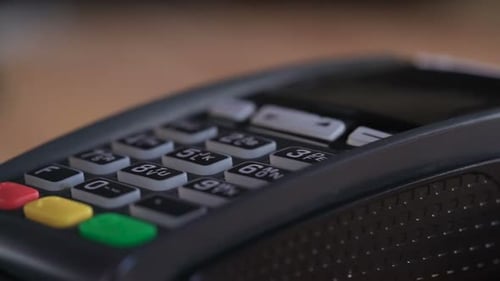 Caucasian man swiping bankcard at store card reader for wireless payment processing