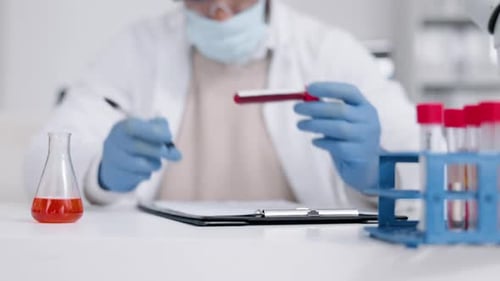 Science, blood and writing with a doctor woman in a laboratory for work on covid research