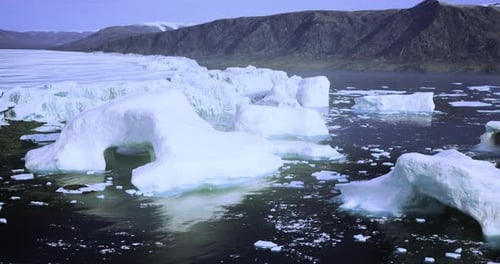 Captivating View of Icebergs Floating in Tranquil Waters Near Greenland