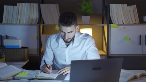 Man Working at Desk Late at Night