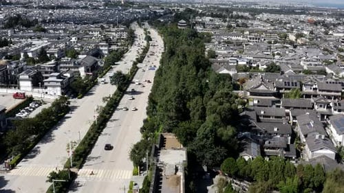 Dali Ancient City wall ruins beside modern urban highway in China, aerial view