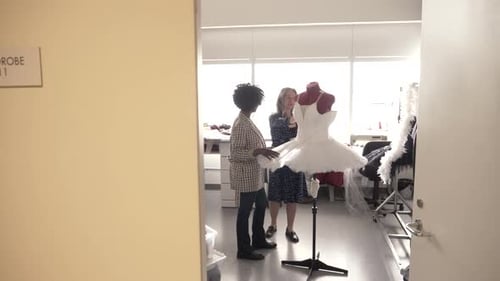 Two Women Discussing a Ballet Tutu in Wardrobe