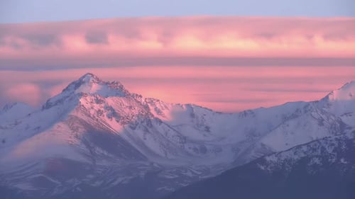 Snowy Mountains at Sunset with Colorful Sky