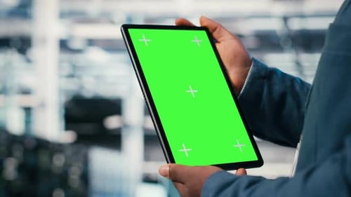 Green Screen Mockup Tablet in Server Room Used By Worker to Enhance Hardware