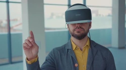 Portrait Attractive Man Making Gestures Swipe When Wearing Virtual Reality Goggles Empty Building