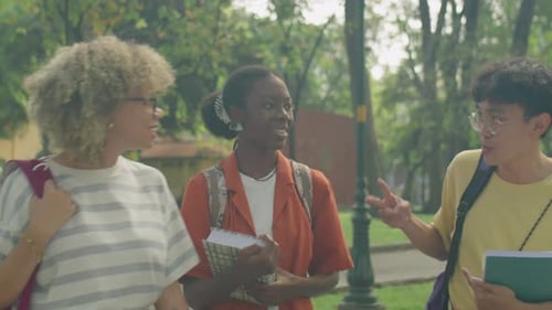 College Friends Chatting on Walk in Park