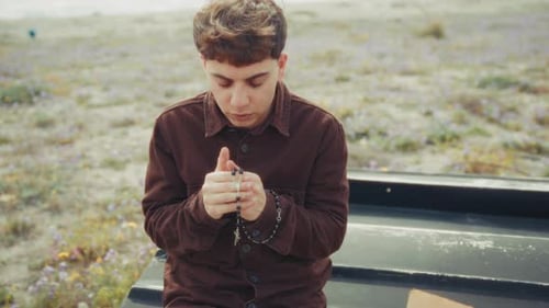 Intense Moment Of Prayer For A Christian Man On The Beach