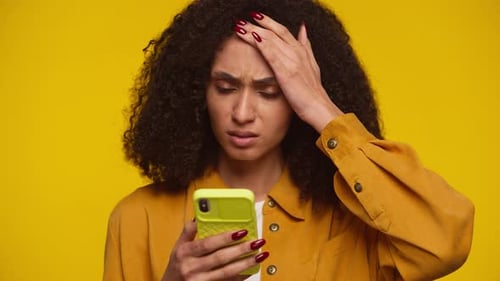 Young Woman Using Mobile Phone, Looking Stressed