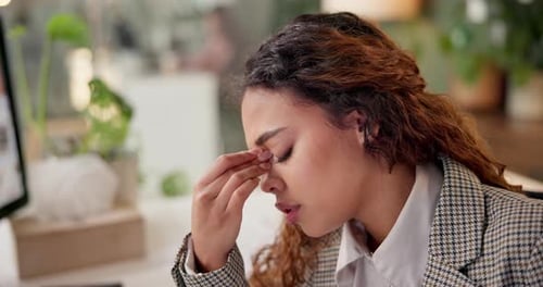 Woman, headache and stress at night in office with pain, tired and frustrated with project review