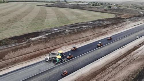 Asphalt Pavers and Rollers Apply Covering on Highway