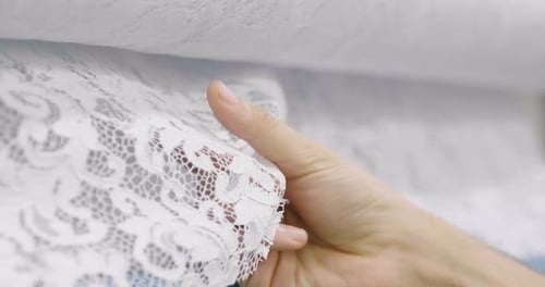 Hand Touching Delicate White Lace Fabric
