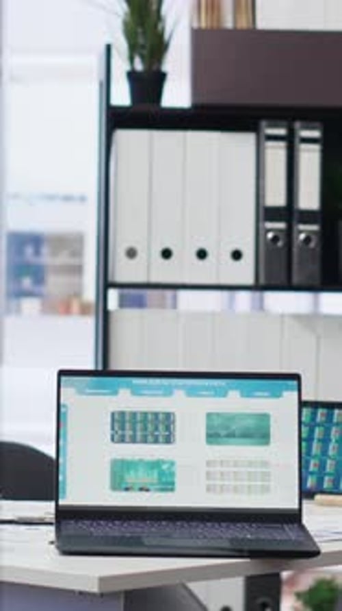 Vertical Video Stock Market Values Going Up and Down on Laptop in Empty Office