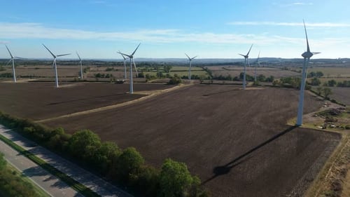 Aerial view of wind turbines near highway, United Kingdom.