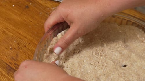 Hands Shaping Dough in a Glass Pie Dish