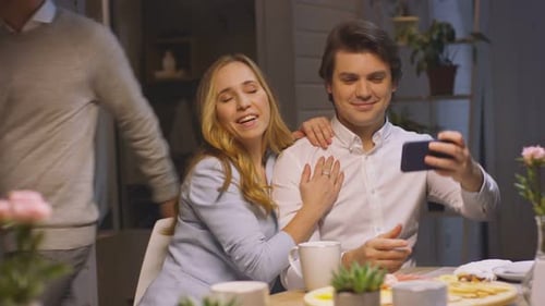 Smiling Couple Taking Selfie Together at Home