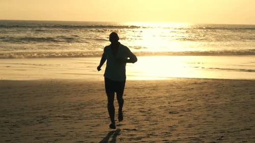 Man Running On Beach During Sunset, Super Slow Motion 120fps
