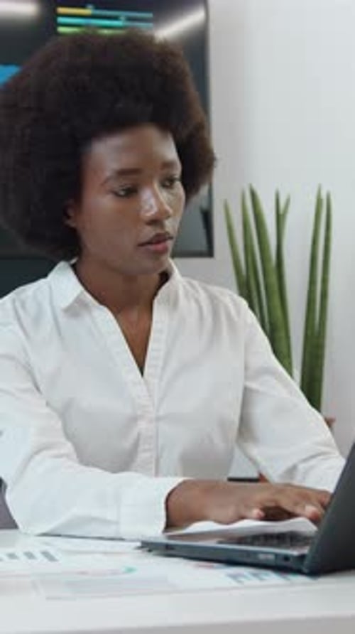 Businesswoman Works on Laptop in Modern Office