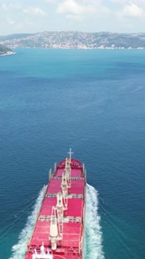 Aerial view a cargo ship through calm waters of Bosporus Sea.