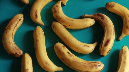 Overhead View of Yellow Bananas on Blue Surface