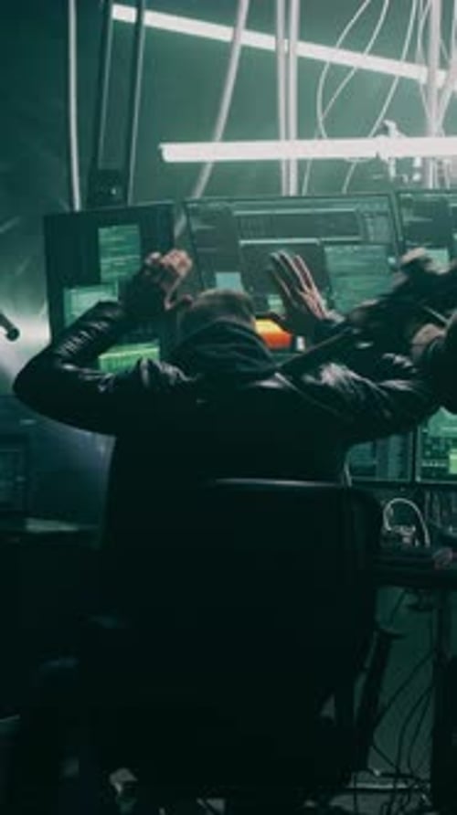 Hacker Surrenders in a Futuristic Workplace at Night