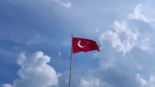 Turkish Flag Waving Proudly Against Blue Sky