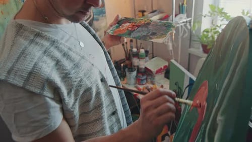 Focused Artist Painting on Canvas in Creative Studio
