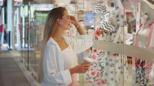 Ambiance of Shopping Mall Caucasian Woman Looking at Storefronts Contemplates About Shopping