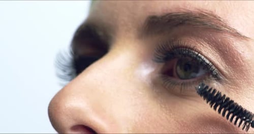 Woman Applies Mascara in Extreme Close-up Shot