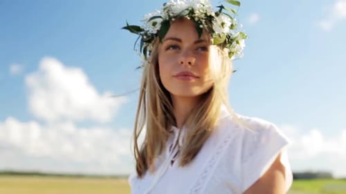 Blonde woman wearing flower crown outside on sunny day