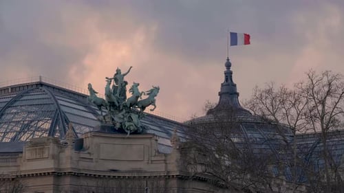 Grand Palais Architecture with French Flag at Sunrise