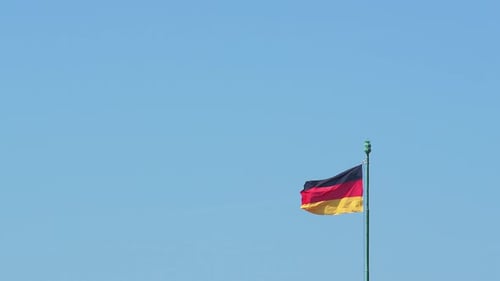 German Flag Waving Against Blue Sky