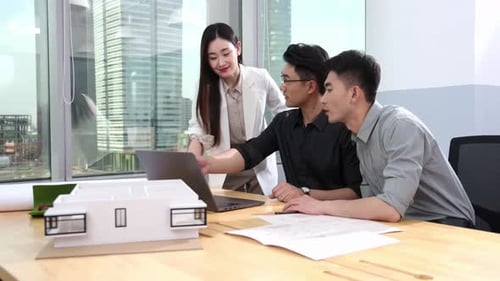 Architects Collaborating on Project in Modern Urban Office