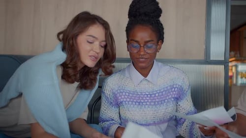 Marketing Female Team Collaborates Discussing Documents in Office